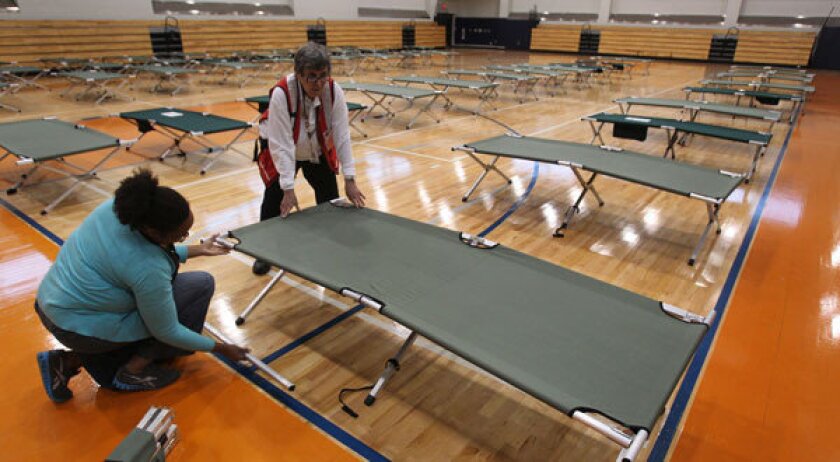 American Red Cross workers set up cots inside the West Philadelphia High School in Philadelphia.