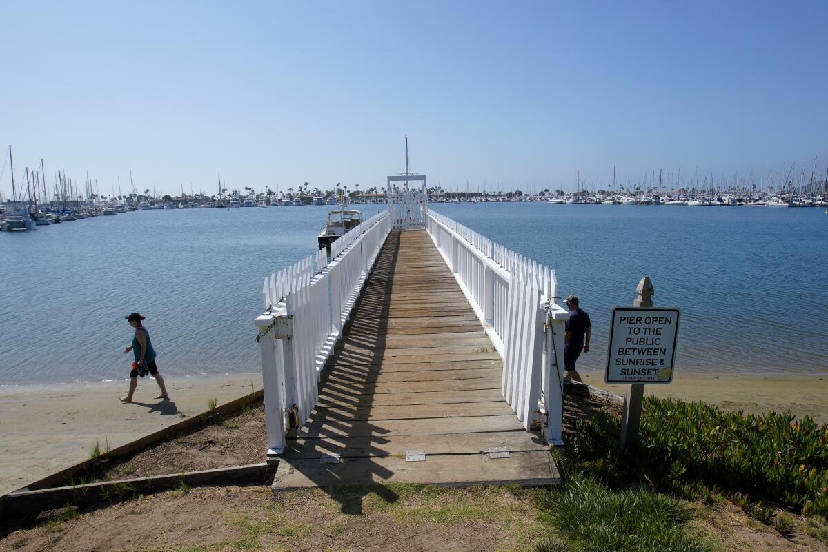 A sign posted on the Wyatt Pier says the pier is open to the public from sunrise to sunset.