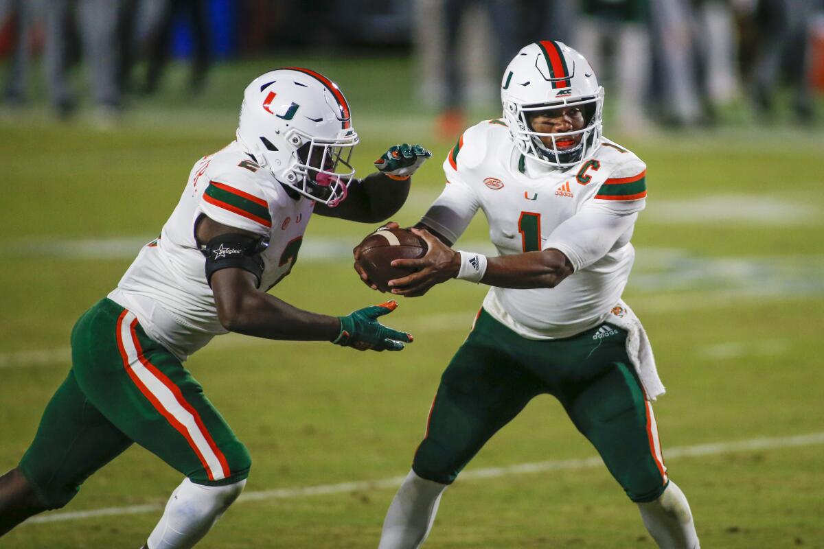 Miami quarterback D'Eriq King hands off to running back Donald Chaney Jr. during the second quarter Saturday.