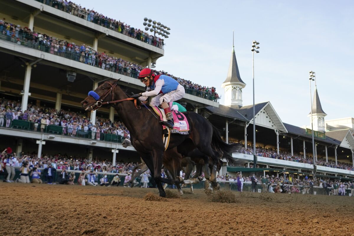 John Velazquez rides Medina Spirit across the finish line.