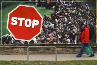 FILE - A man walks by an anti-migration billboard from the Hungarian government, on a street in Budapest, Hungary, April 7, 2018. (AP Photo/Darko Vojinovic, File)