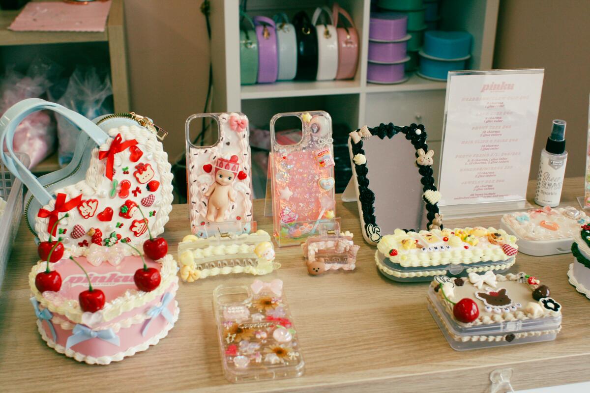Decorated phone cases and other items on a counter at Pinku