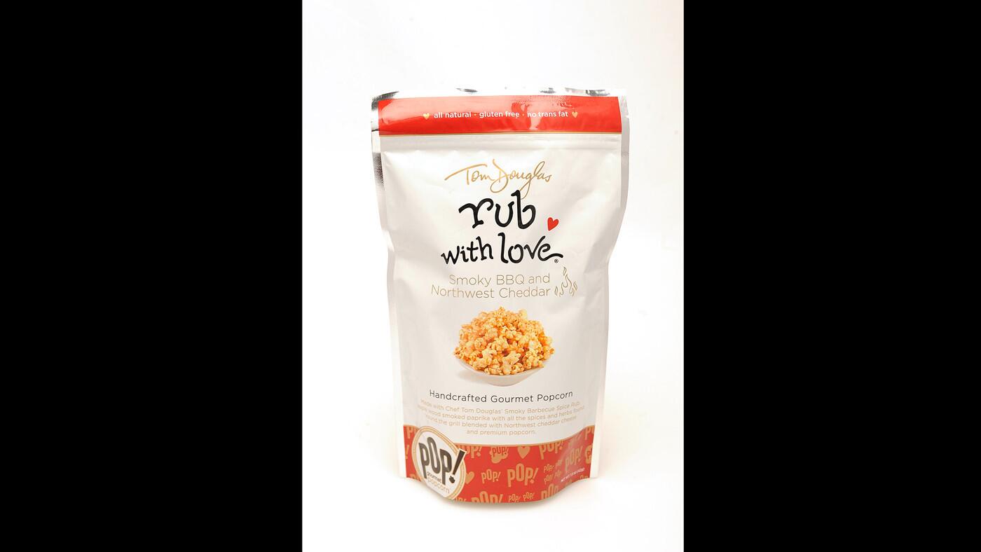 A bag of Tom Douglas Rub With Love Smoky BBQ and Northwest Cheddar Gourmet Popcorn. According to the Popcorn Board, Americans consume 16 billion quarts of popped popcorn annually.