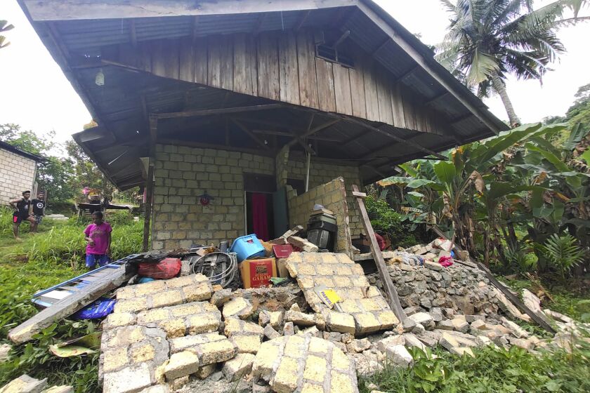 This photo released by Indonesia's National Disaster Management Agency (BNPB) shows a damaged house following an earthquake in Jayapura, Papua province, Thursday, Feb. 9, 2023. The shallow earthquake shook the country's easternmost province of Papua on Thursday, killing a number of people. (BNPB via AP)