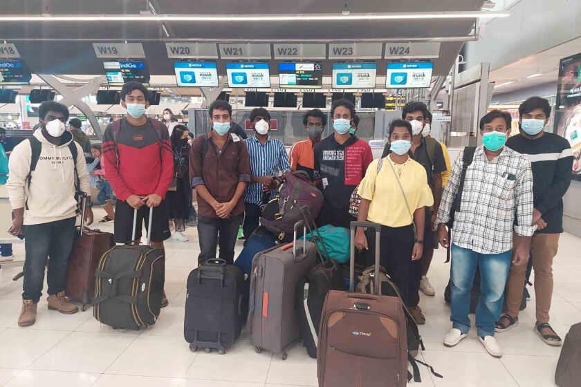 In this photo provided by the Ministry of External Affairs, Indian workers rescued after they were lured by agents for fake job opportunities in the information technology sector in Thailand arrive at the airport in Chennai, India, Wednesday, Oct. 5, 2022. Arindam Bagchi, the External Affairs Ministry spokesperson, said some fraudulent IT companies appear to be engaged in digital scamming and forged cryptocurrencies. The Indian workers were held captive and forced to commit cyber fraud, he told reporters. (Ministry of External Affairs via AP)