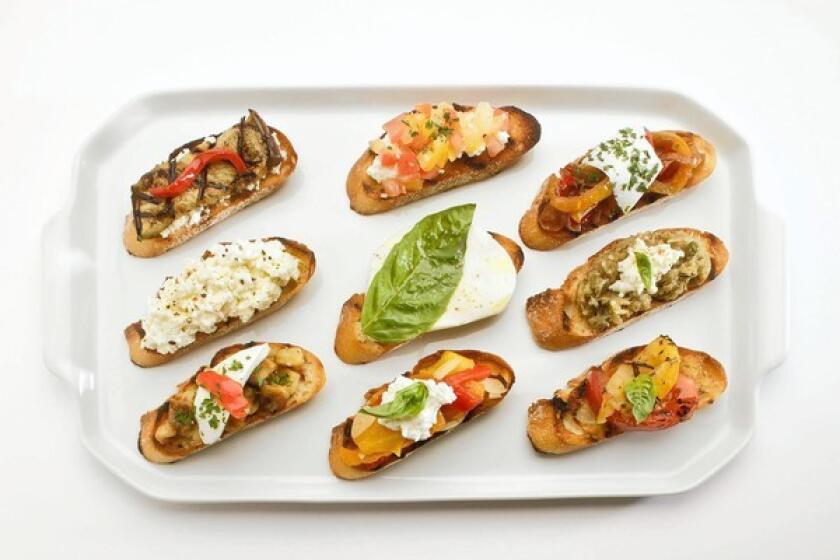 A platter of bruschetta shows the variety of toppings for this simple concept.