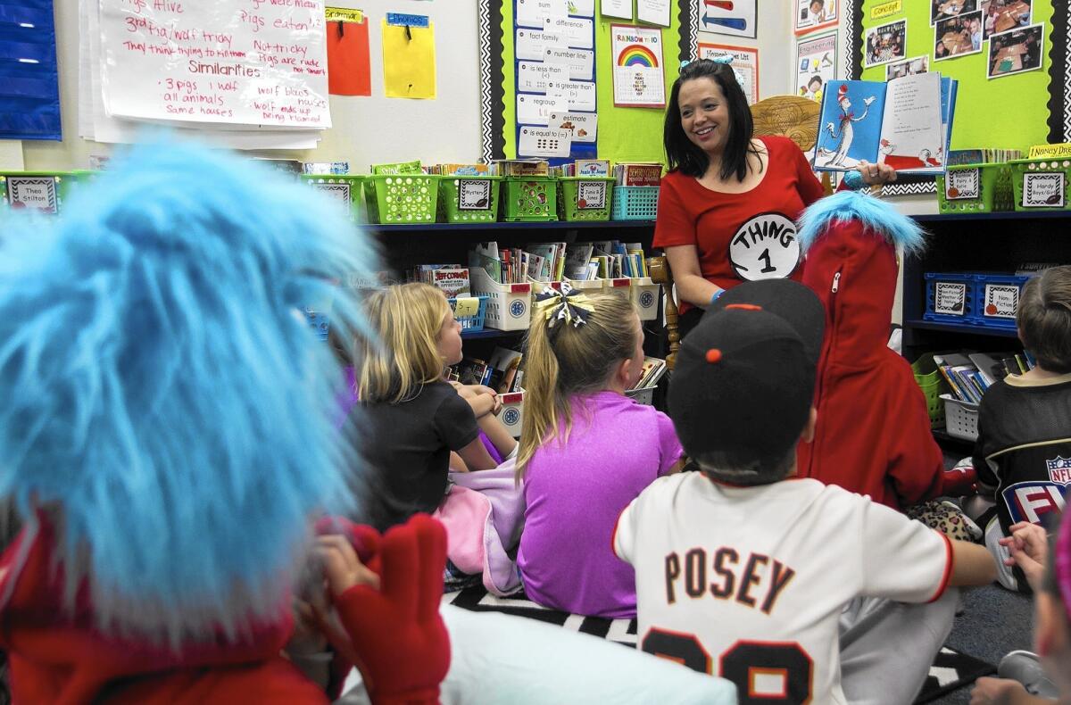 Reggie Biancalini reads "The Cat in the Hat" book to Mariners Christian School students on March 2, 2016.