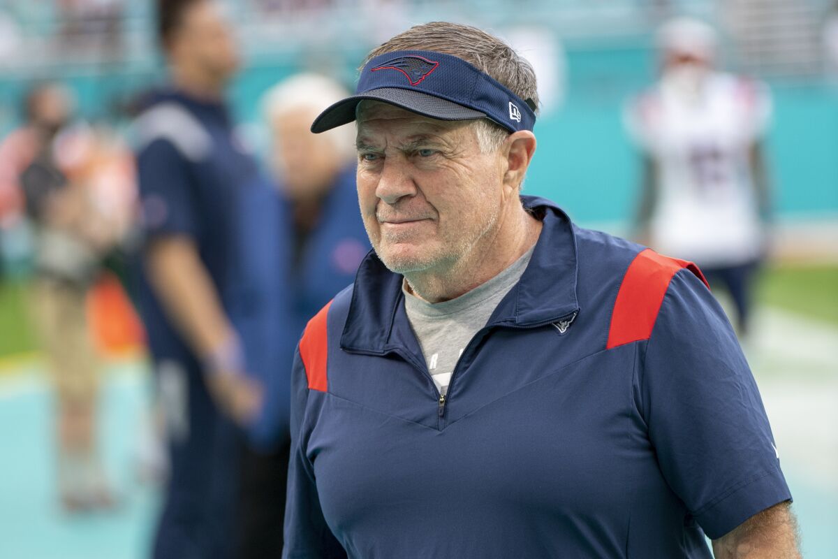 FILE - New England Patriots head coach Bill Belichick walks on the sidelines before an NFL football game against the Miami Dolphins, Sunday, Jan. 9, 2022, in Miami Gardens, Fla. The Patriots spent heavily in free agency last offseason and got great production in return from new additions. It helped get New England back to the playoffs after a one-year absence. (AP Photo/Doug Murray, File)