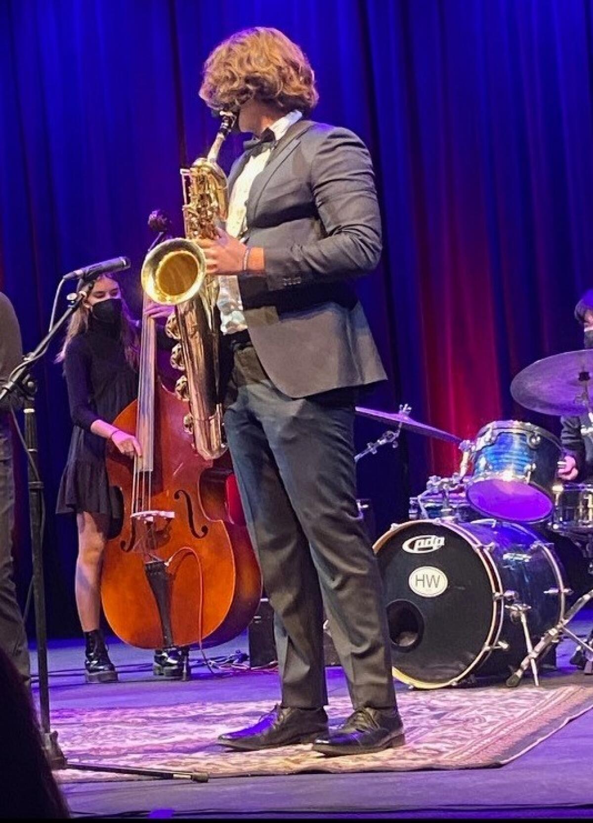 Harvard-Westlake High's Kai Faucher plays his baritone saxophone.