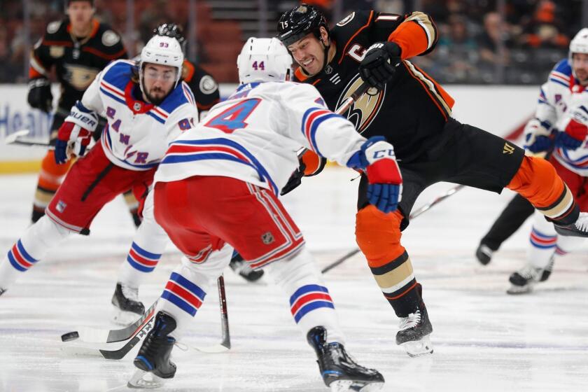 ANAHEIM, CA - NOVEMBER 01: Ryan Getzlaf #15 of the Anaheim Ducks shoots the puck between the defense of Neal Pionk #44 and Mika Zibanejad #93 of the New York Rangers during the first period of a game at Honda Center on November 1, 2018 in Anaheim, California. (Photo by Sean M. Haffey/Getty Images) ** OUTS - ELSENT, FPG, CM - OUTS * NM, PH, VA if sourced by CT, LA or MoD **