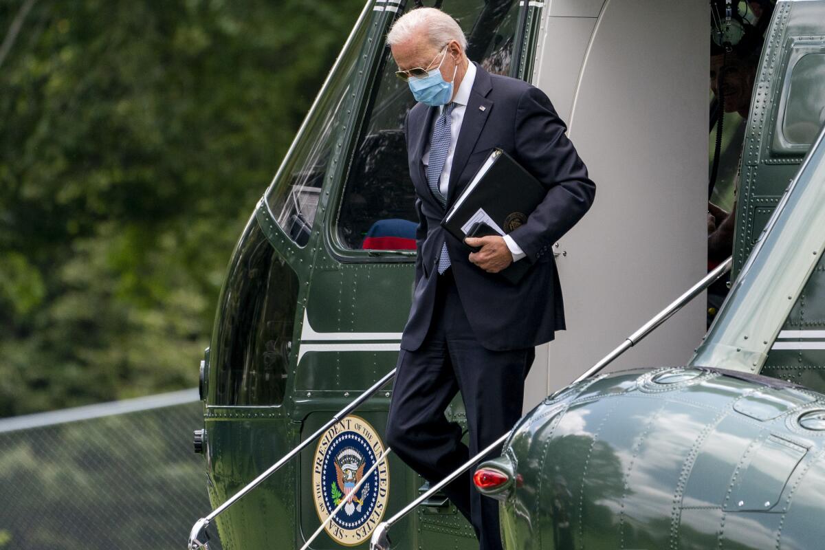 President Biden steps out of a helicopter at the White House