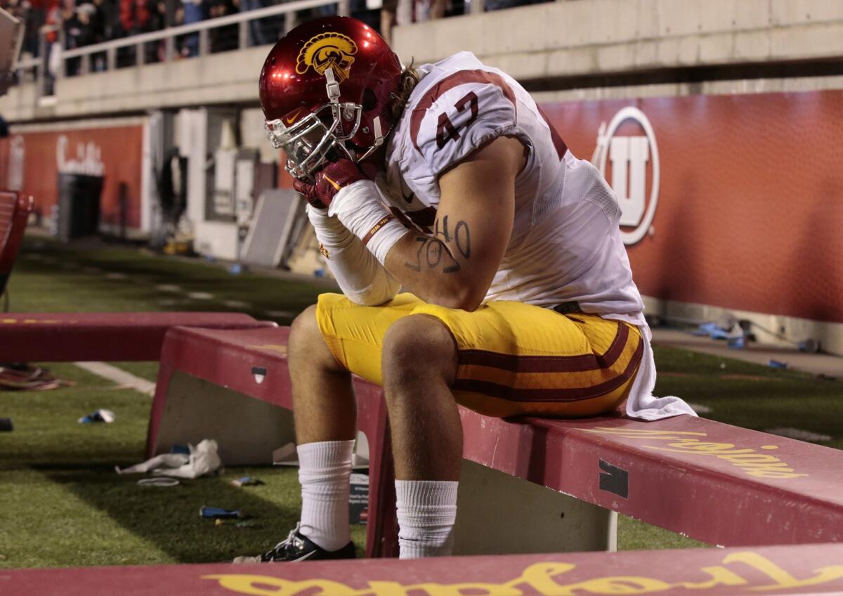 USC linebacker Scott Felix sits alone on the Trojans' sideline following a 24-21 loss at Utah on Oct. 25.