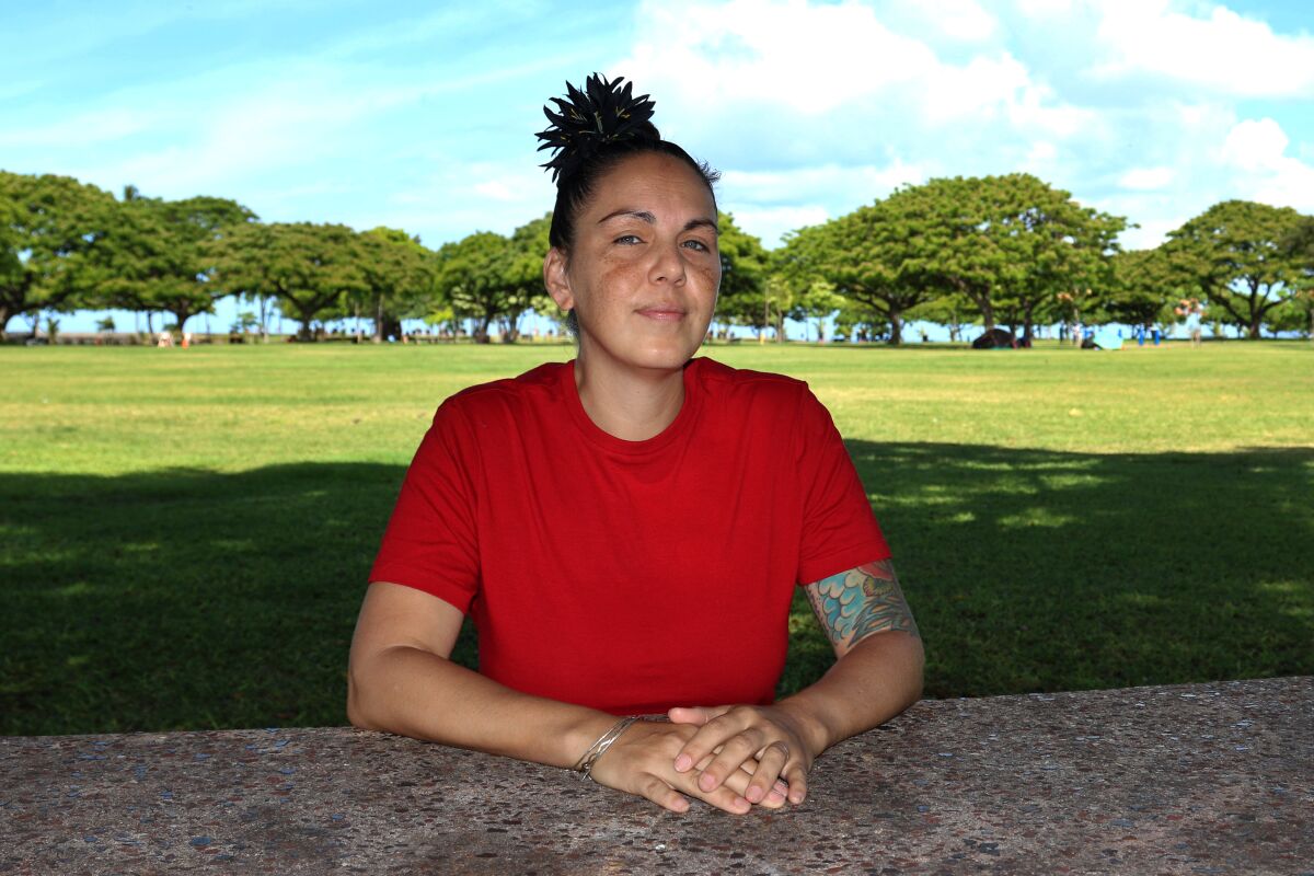 Ashley Maha'a sits in a park in Honolulu on June 22, 2021. “I’ve met so many people on the mainland, and so, so, so many of them have told me that when they were being trafficked nationally, they would be flown here for a period of time and work here when things were slow, because the demand is so high,” Maha'a says. (AP Photo/Audrey McAvoy)