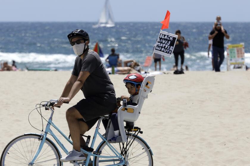 LOS ANGELES, CA - JUNE 07: A Black Lives Matter message flies on a bike at Venice Beach, CA on Sunday, June 7, 2020. (Myung J. Chun / Los Angeles Times)