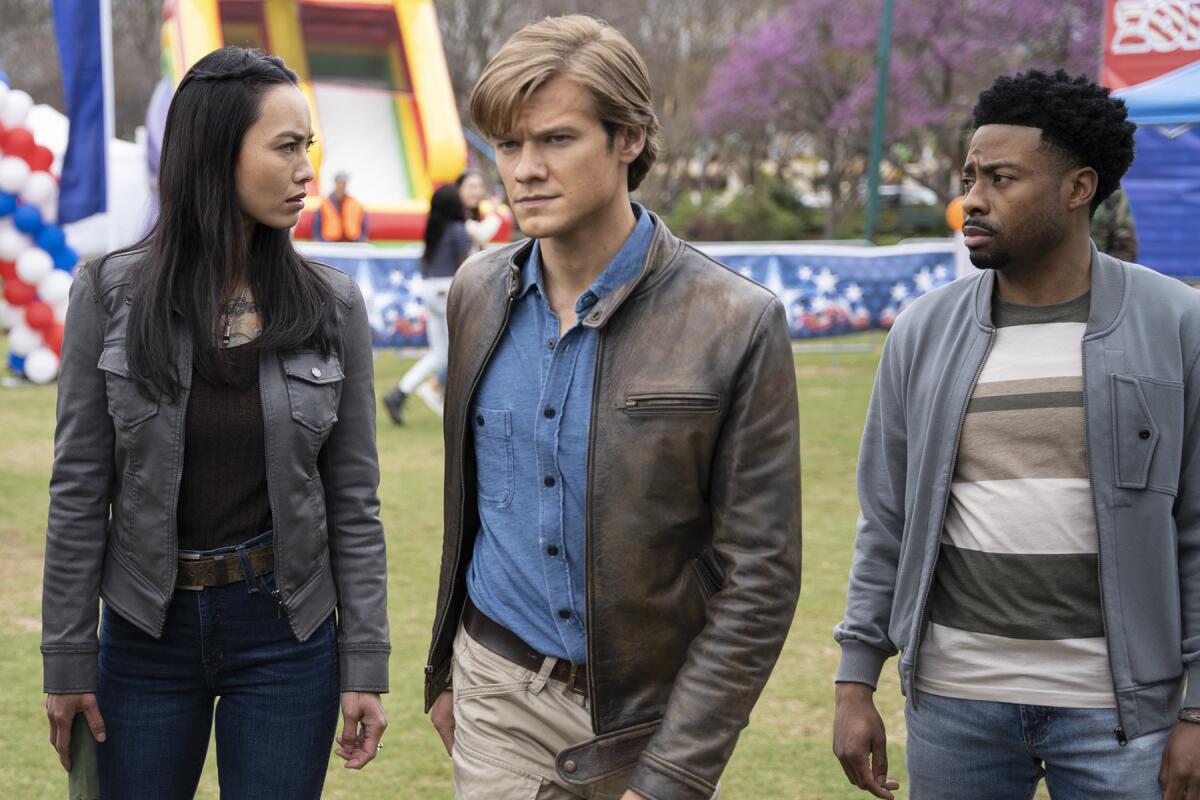  Levy Tran, left, Lucas Till and Justin Hires at an outdoor carnival.