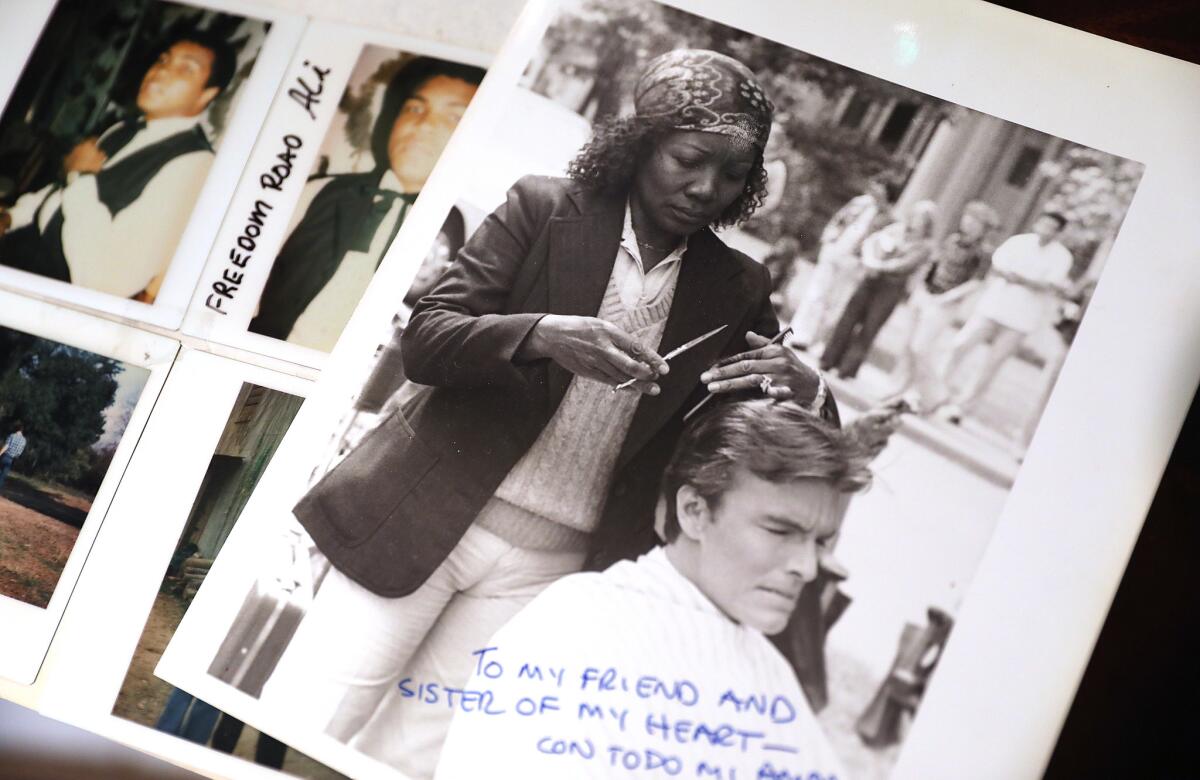 A photo of Ora Green grooming Edward Albert's hair