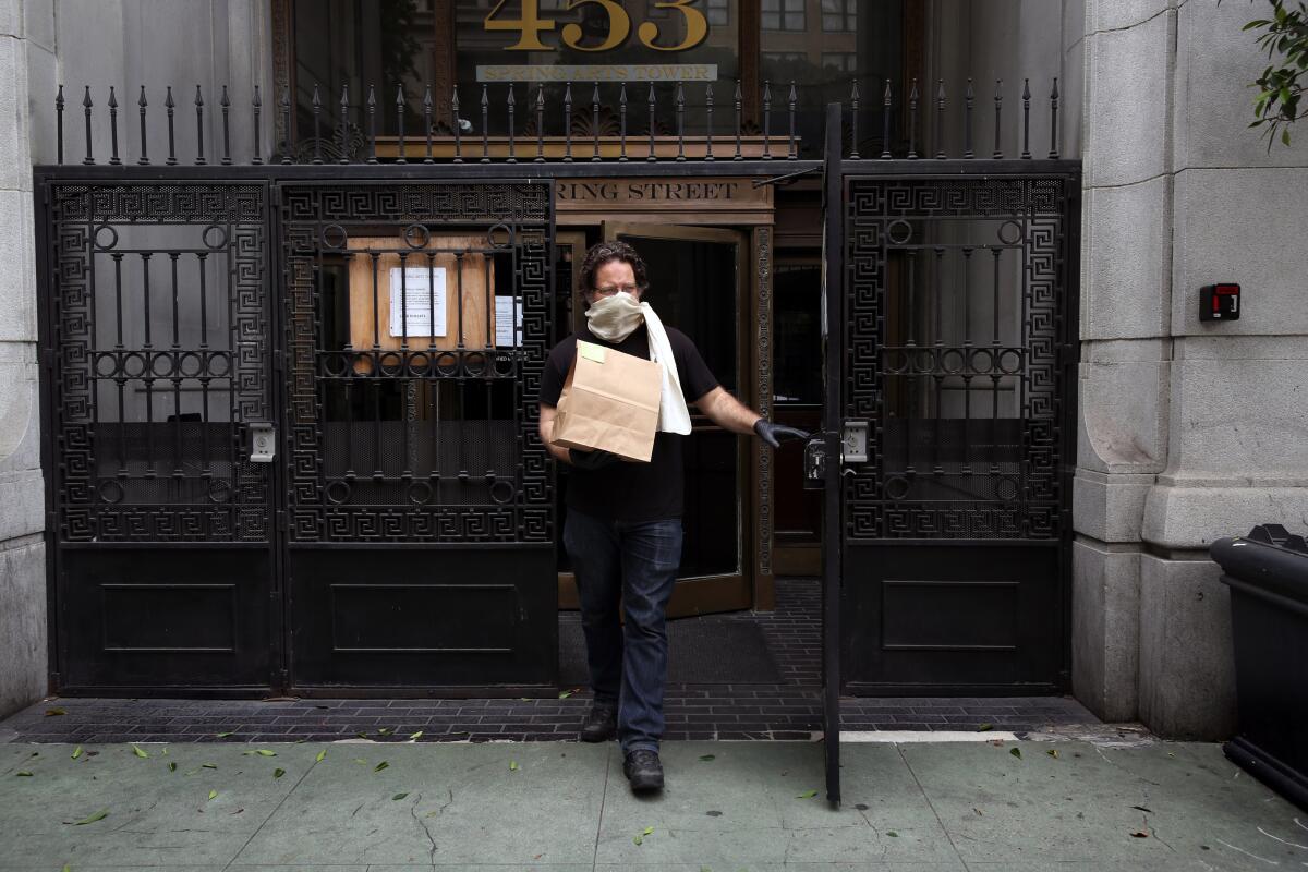 Eric Larkin steps out to deliver an order to a customer at the Last Bookstore. 