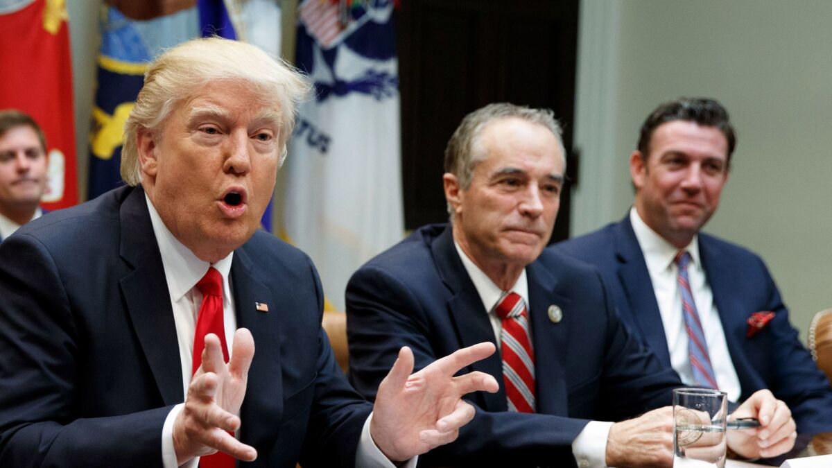 President Donald Trump speaks during a meeting with House Republicans in the Roosevelt Room of the White House in Washington in February, 2017. Seated next to Trump are Rep. Chris Collins, R-N.Y., and Rep. Duncan Hunter, R-Alpine, both of whom have since pleaded guilty to federal offenses.
