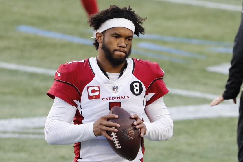 Arizona Cardinals quarterback Kyler Murray on the sidelines during an NFL football game.