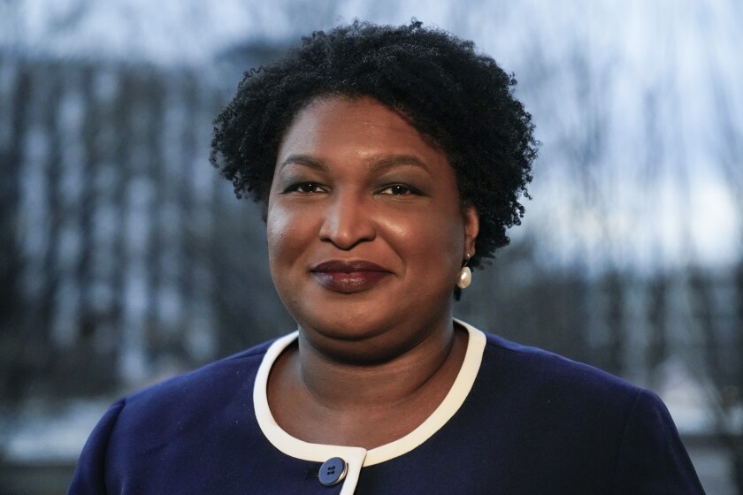 FILE - Georgia gubernatorial Democratic candidate Stacey Abrams poses for a photo during an interview with The Associated Press on Dec. 16, 2021, in Decatur, Ga. Abrams was missing Tuesday when President Joe Biden swung through the city to press for voting rights protections. During a day that was shrouded in the city's legacy as the cradle of the Civil Rights Movement, the absence of one of the nation's most prominent voting rights activists sparked something of an awkward moment. (AP Photo/Brynn Anderson, File)