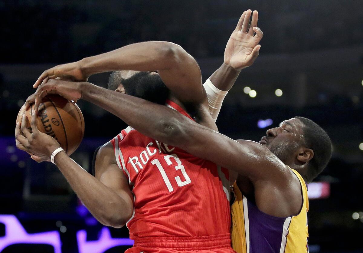 Rockets guard James Harden is fouled by Lakers center Roy Hibbert during a game on Dec. 17.