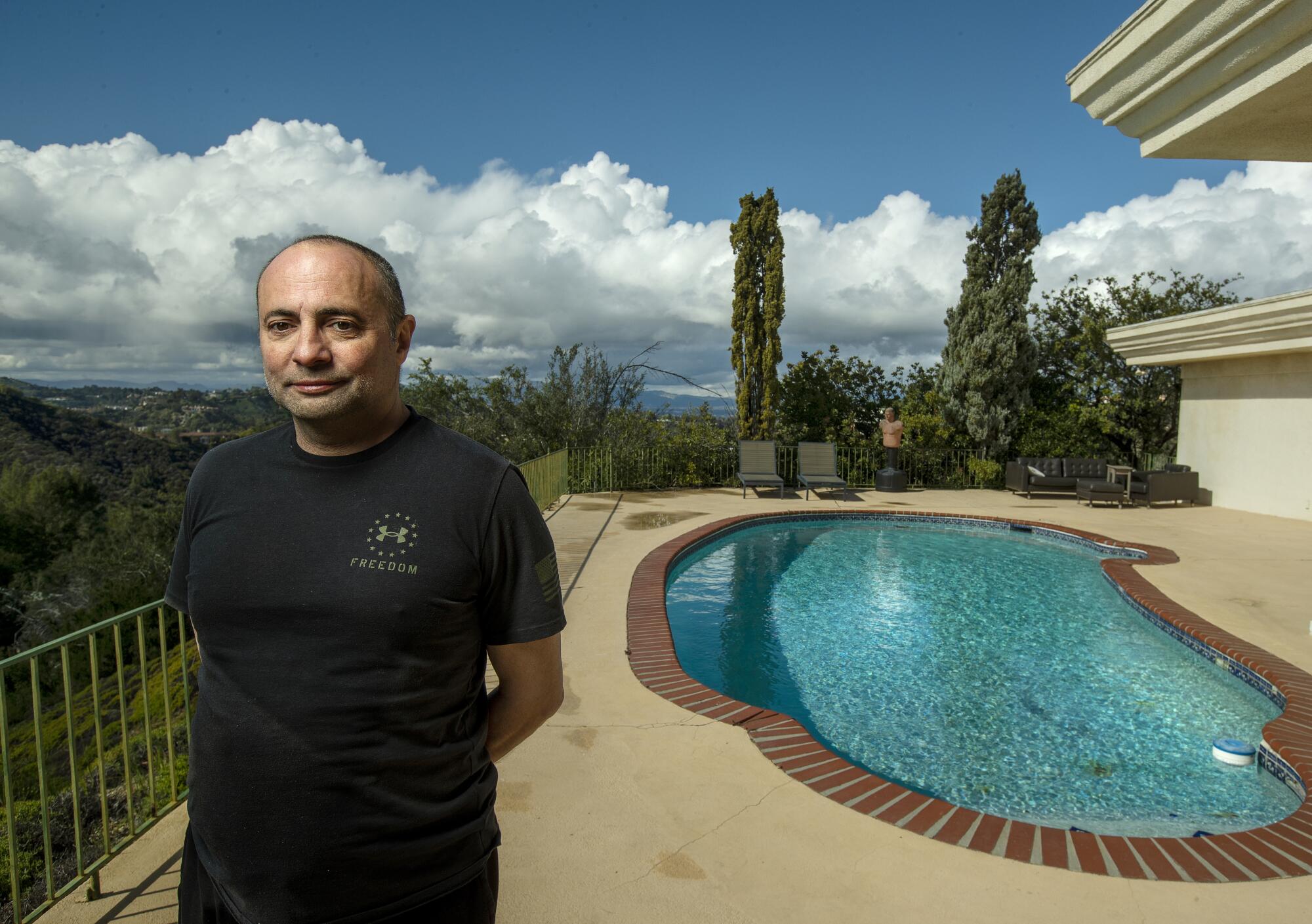 Ashot Yegiazaryan stands near a swimming pool at his home
