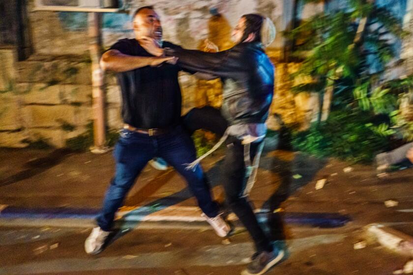 A Palestinian and Jewish settler confront each other in a brawl in the Sheikh Jarrah neighborhood of Jerusalem.