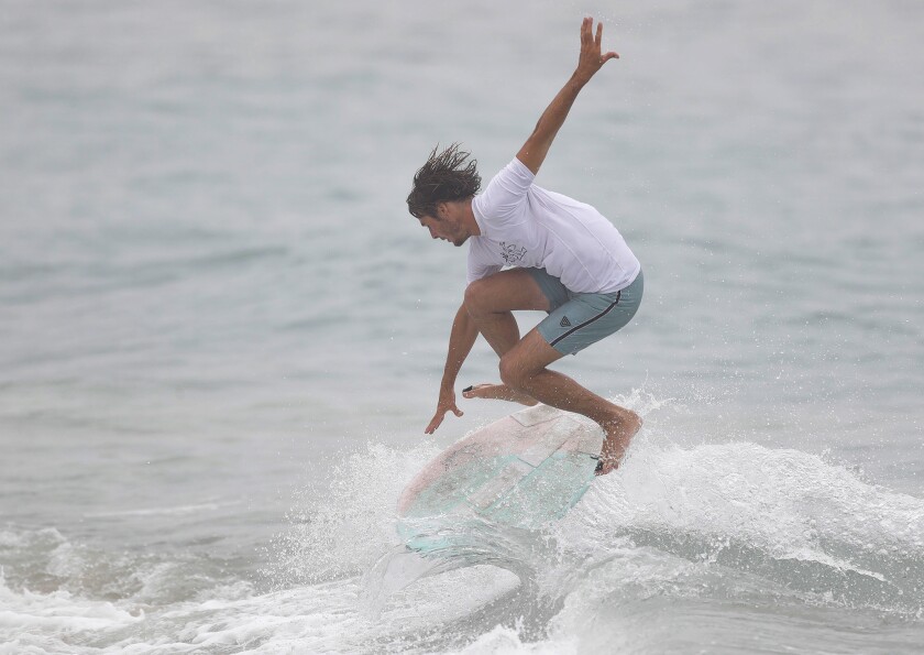 Johnny Webber completes a "360-pop-shove" move at "The Vic" skimboard contest.