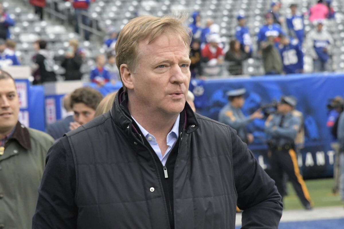 NFL Commissioner Roger Goodell walks on the field before a game.
