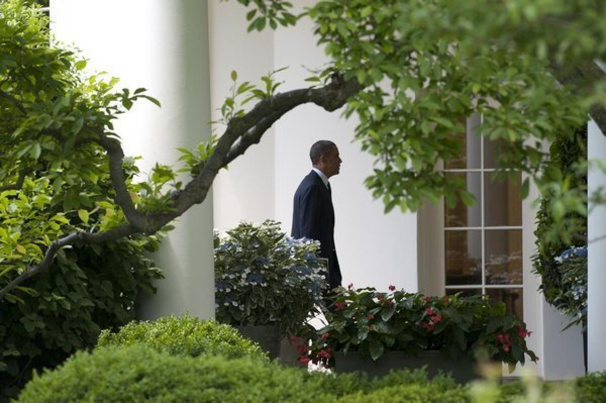 President Obama walks to the Oval Office at the White House in Washington.