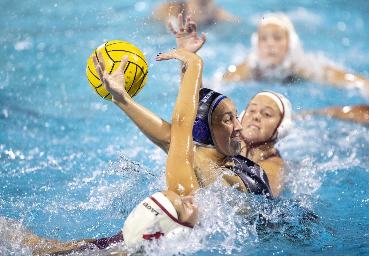 Newport Harbor's Lily Gess takes a shot under pressure from Laguna Beach's Ava Houlahan during Tuesday's Surf League match.