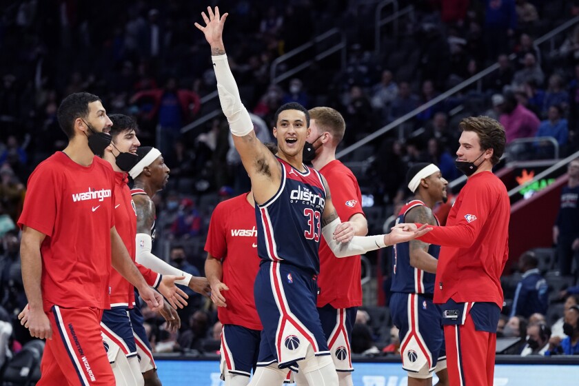 Washington Wizards forward Kyle Kuzma (33) waves off the crowd after hitting a 3-point basket in the closing seconds during overtime to defeat the Detroit Pistons in an NBA basketball game, Wednesday, Dec. 8, 2021, in Detroit. (AP Photo/Carlos Osorio)
