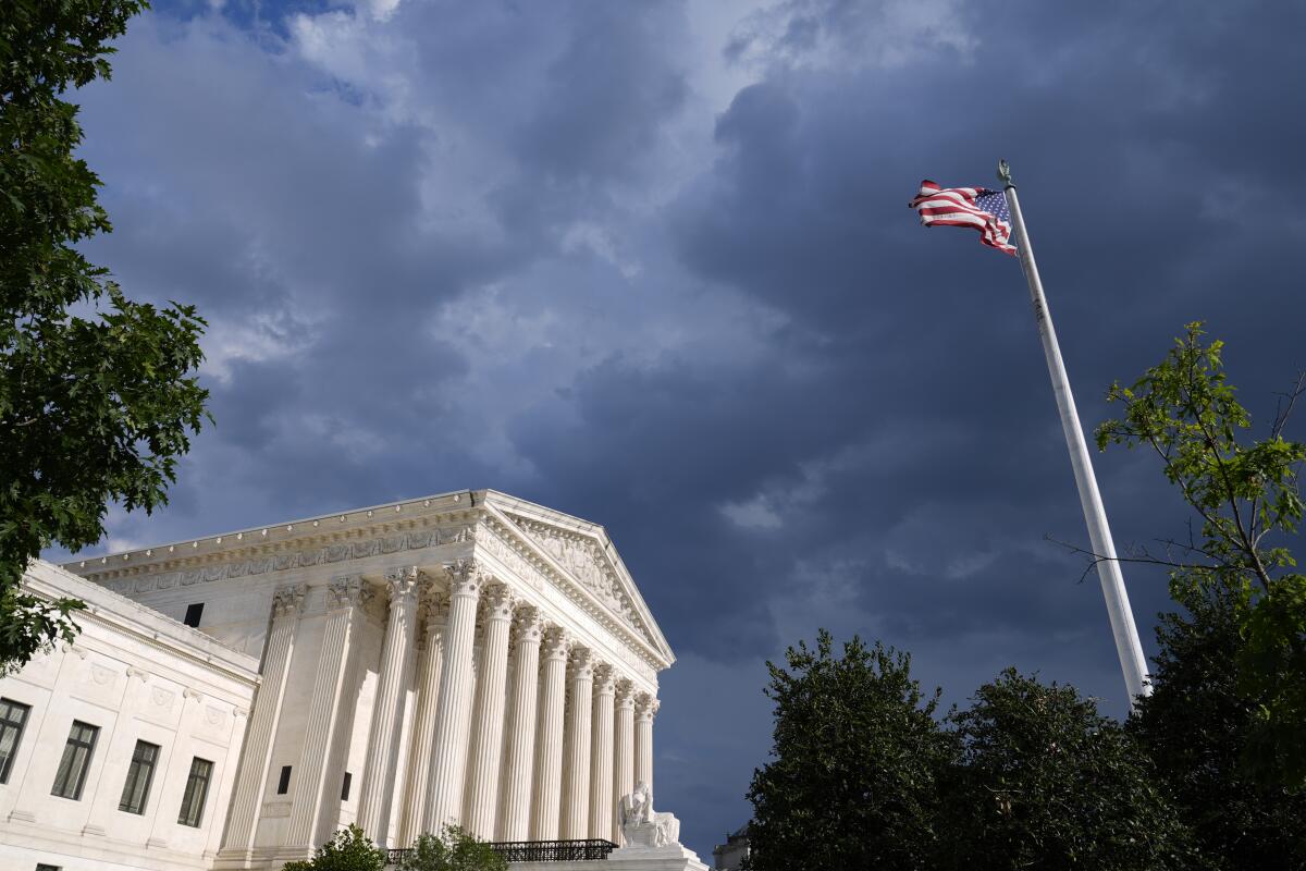 The Supreme Court under a cloudy sky. 