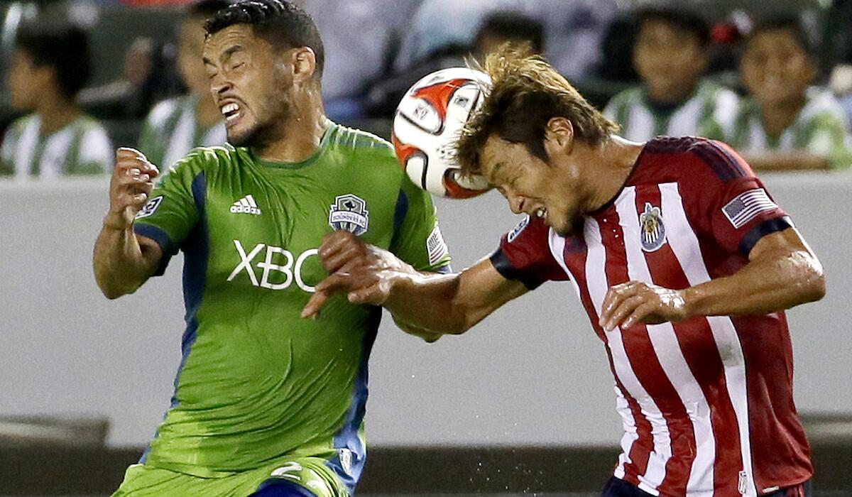 Chivas USA defender Akira Kaji, right, heads the ball away from Sounders midfielder Lamar Neagle in the first half of a game earlier this month at StubHub Center.