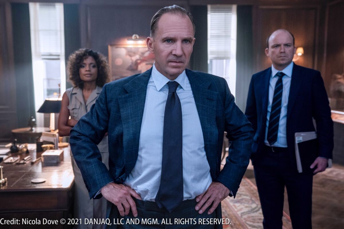 (L-R) Moneypenny, M & Tanner in M’s office