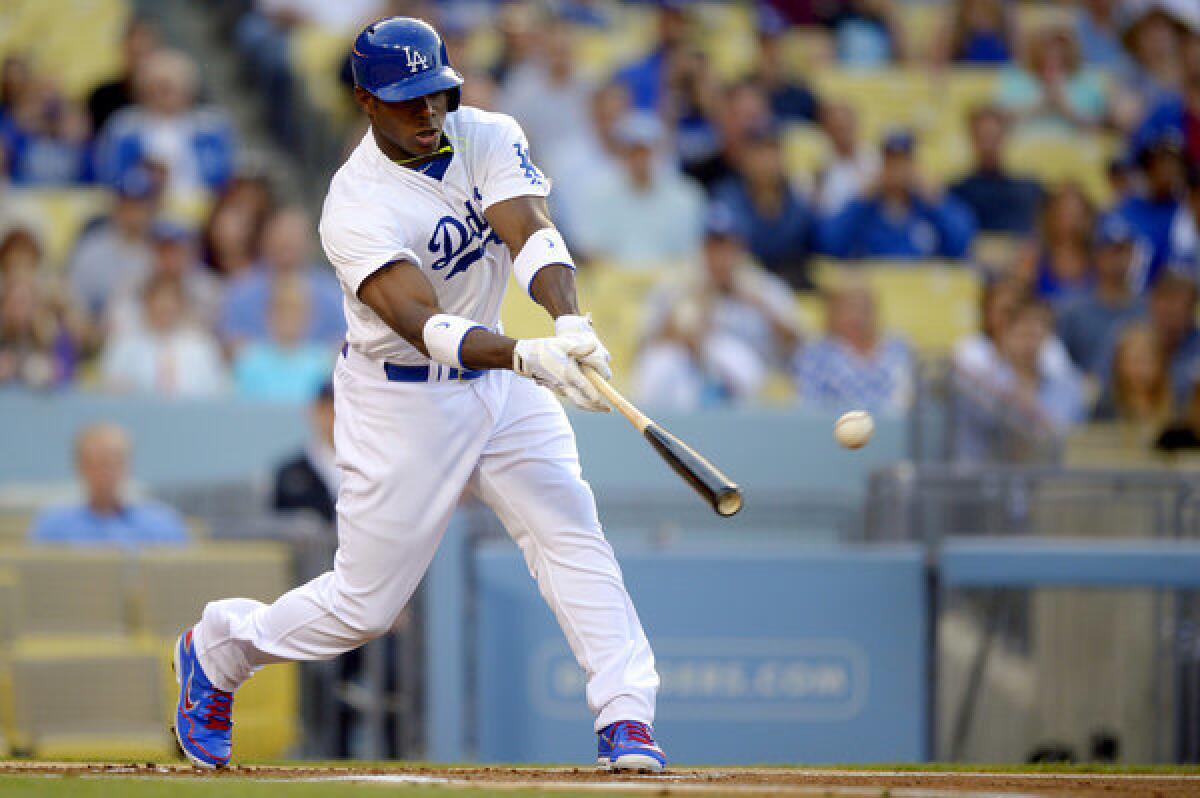Dodgers' Yasiel Puig singles in his first major-league at-bat during the first inning.