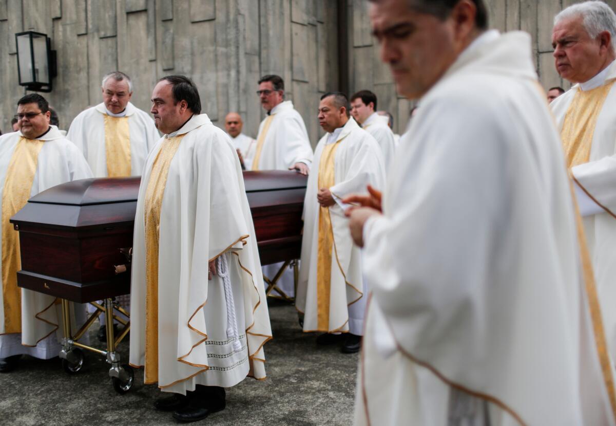 The casket of the Rev. Eric Freed is moved after the funeral service at the Sacred Heart Church in Eureka on Monday.