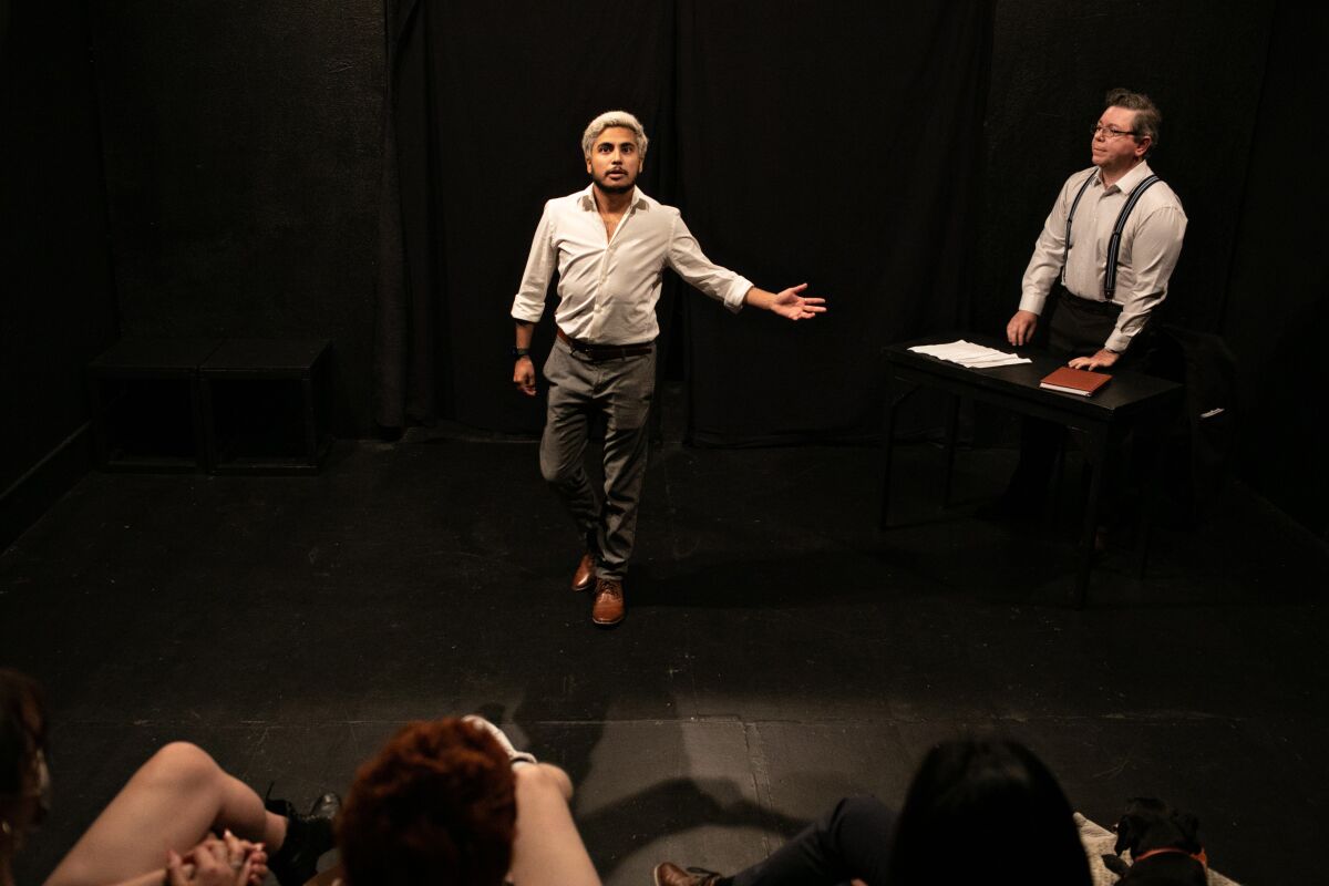 Two people perform a scene for class. 