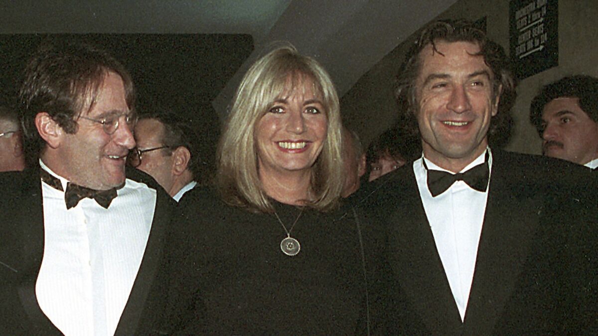 In this 1990 file photo, director Penny Marshall poses with co-stars of "Awakenings" Robin Williams, left, and Robert De Niro at the premiere of the film in New York.