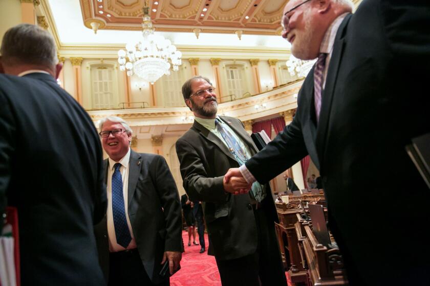 Sen. John Moorlach (R-Costa Mesa), second from right, bids farewell to fellow lawmakers at the end of the Senate floor session in Sacramento on Sept. 11, 2015. Moorlach is a leading voice in the Legislature against skyrocketing debt being piled up by public pension systems.