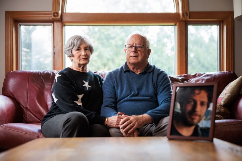 04/18/2023 Warwick, RI Celia (left) and Terry Harms (cq) at their home in Warwick, RI. Their son Jonathan Harms (portrait visible) died in 2017 after receiving fentanyl-tainted pills. (Aram Boghosian/For The Times)