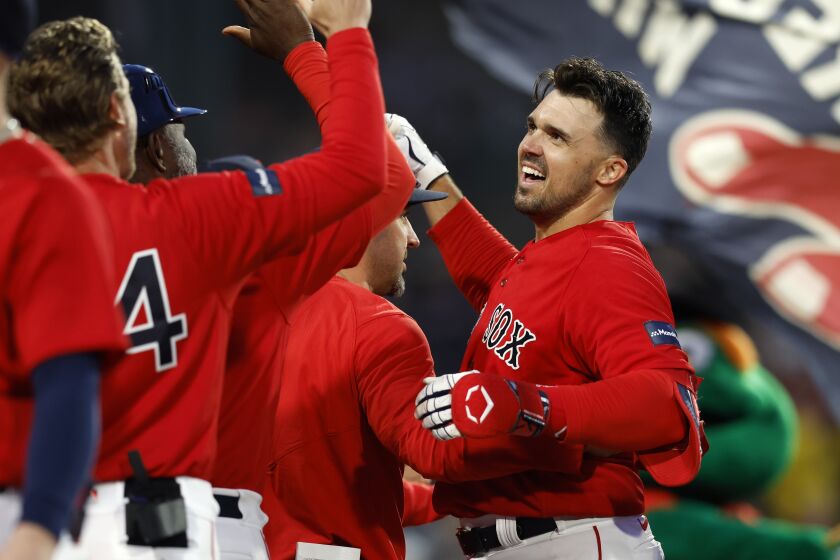 Boston Red Sox's Adam Duvall, right, celebrates teammates after his two-run, walk-off home run in the ninth inning of a baseball game against the Baltimore Orioles, Saturday, April 1, 2023, in Boston. (AP Photo/Michael Dwyer)