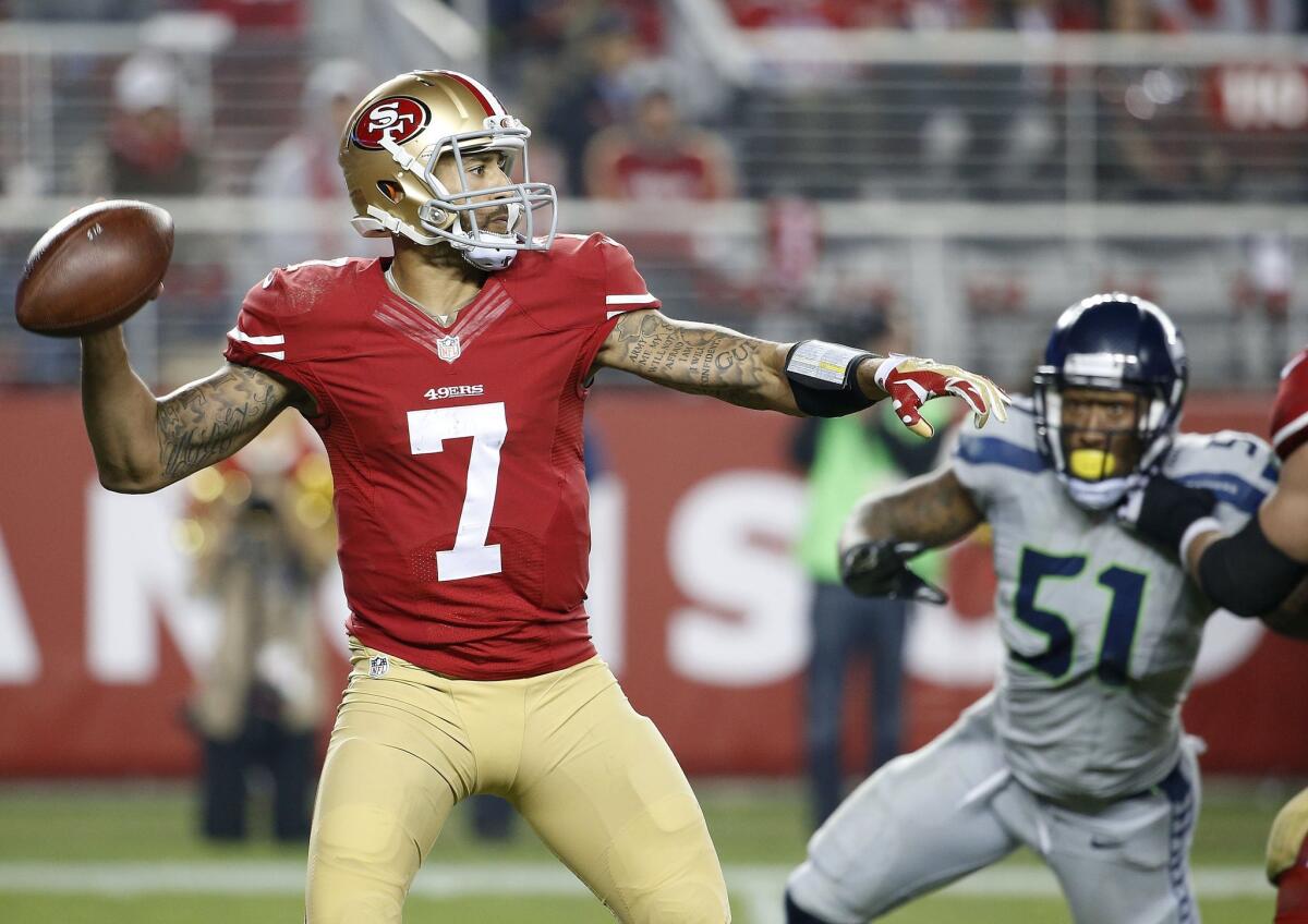 San Francisco 49ers quarterback Colin Kaepernick sets up to pass against the Seattle Seahawks in the teams' NFL game Thursday night, broadcast by NBC.