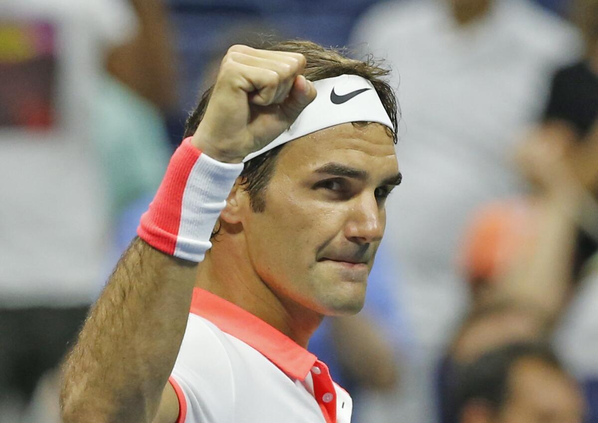 Roger Federer, of Switzerland, reacts after winning his fourth round match against John Isner, 7-6, 7-6, 7-5, at the U.S. Open tennis tournament in New York, Monday, Sept. 7, 2015. (AP Photo/Kathy Willens)