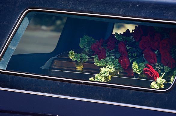 A close-up view of Michael Jackson's casket draped with red roses as his body is transported from Forest Lawn Memorial Park in Hollywood Hills to Staples Center after a private memorial.