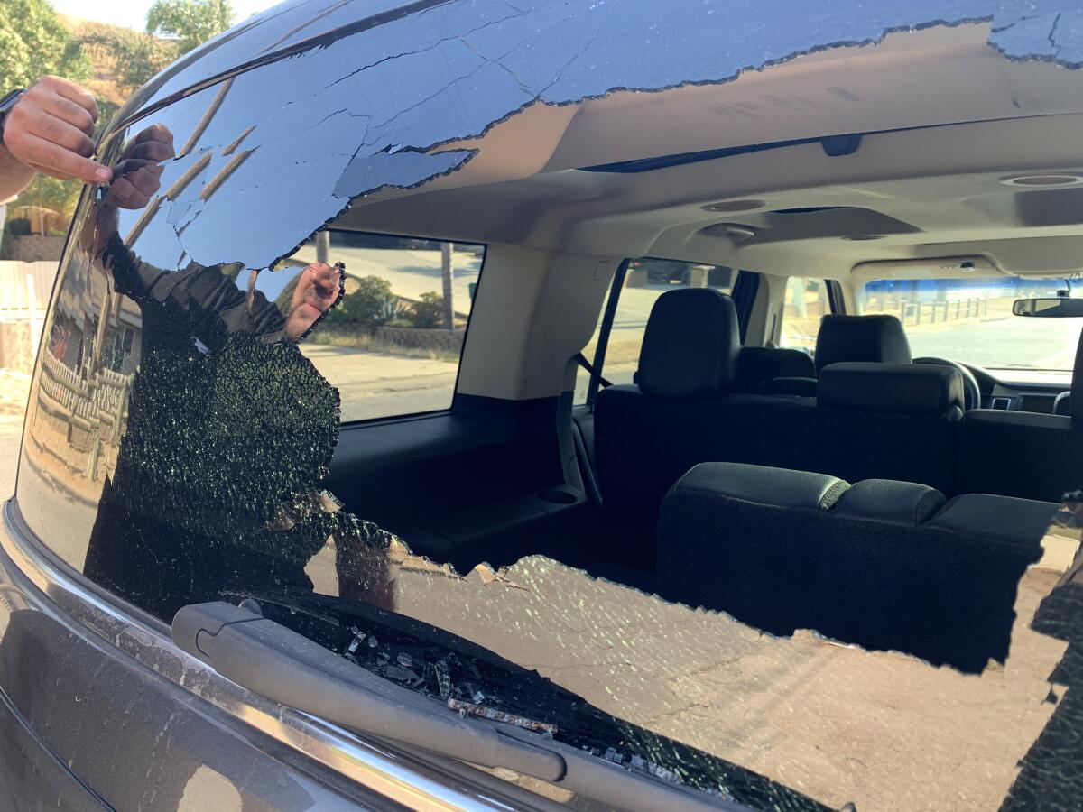 A shattered rear window of an SUV