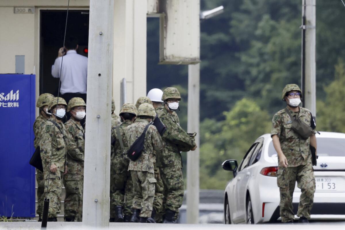 Japanese service personnel gathering near an army base firing range