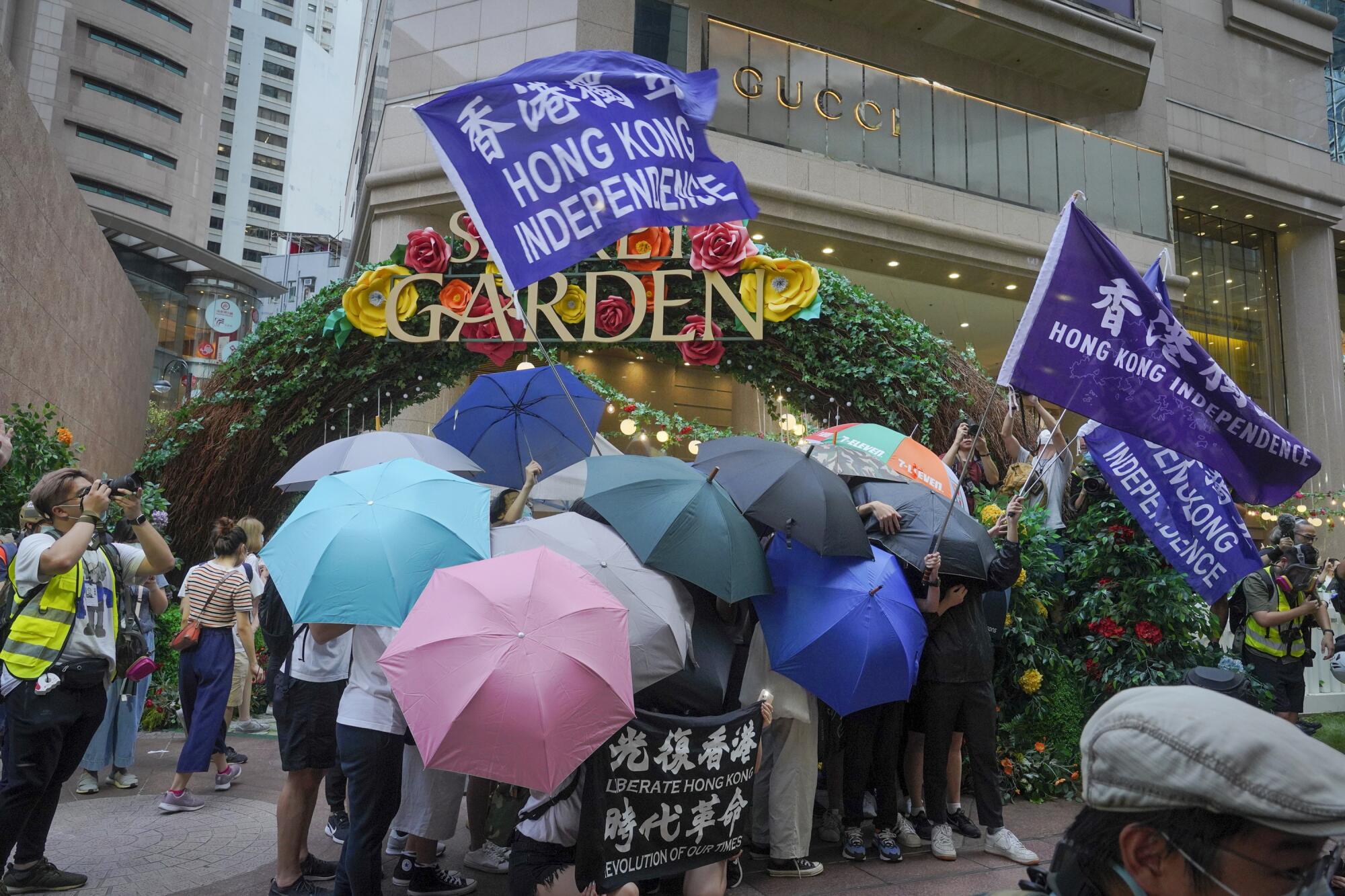 Protesters in Hong Kong set up a defense shield using umbrellas.