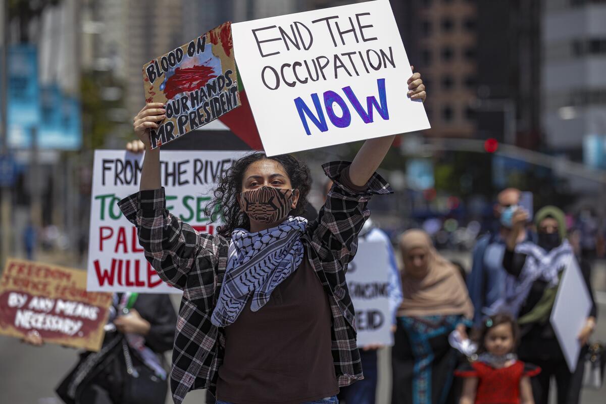 Protesters hold signs at a rally