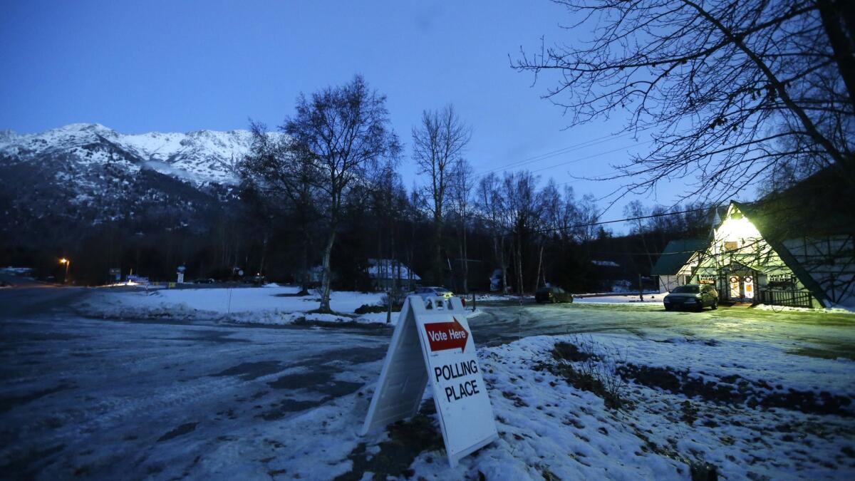 A sign directs voters to the Valley Bible Chalet polling place on Tuesday in Indian, Alaska, south of Anchorage.